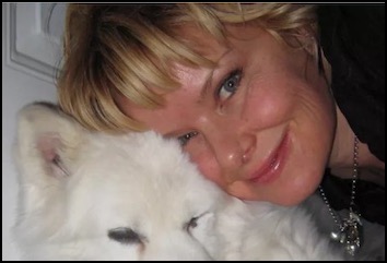 Woman smiling with white dog