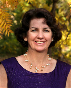 Woman with purple shirt and yellow leaves behind