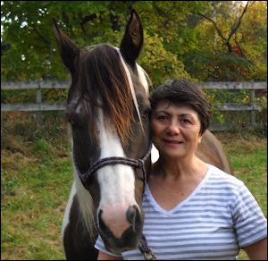 Woman standing with horse