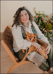 Woman with gold dog in lap