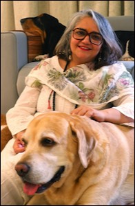 Woman seated with dogs